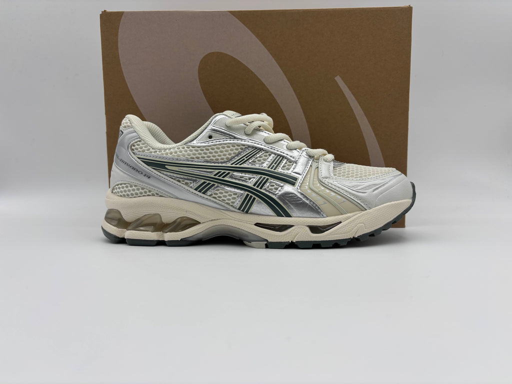Side view of Asics Gel-Kayano 14 Birch Dark Pewter running shoes with cushioned GEL midsole, breathable mesh and synthetic upper, and durable rubber outsole for comfort and performance.