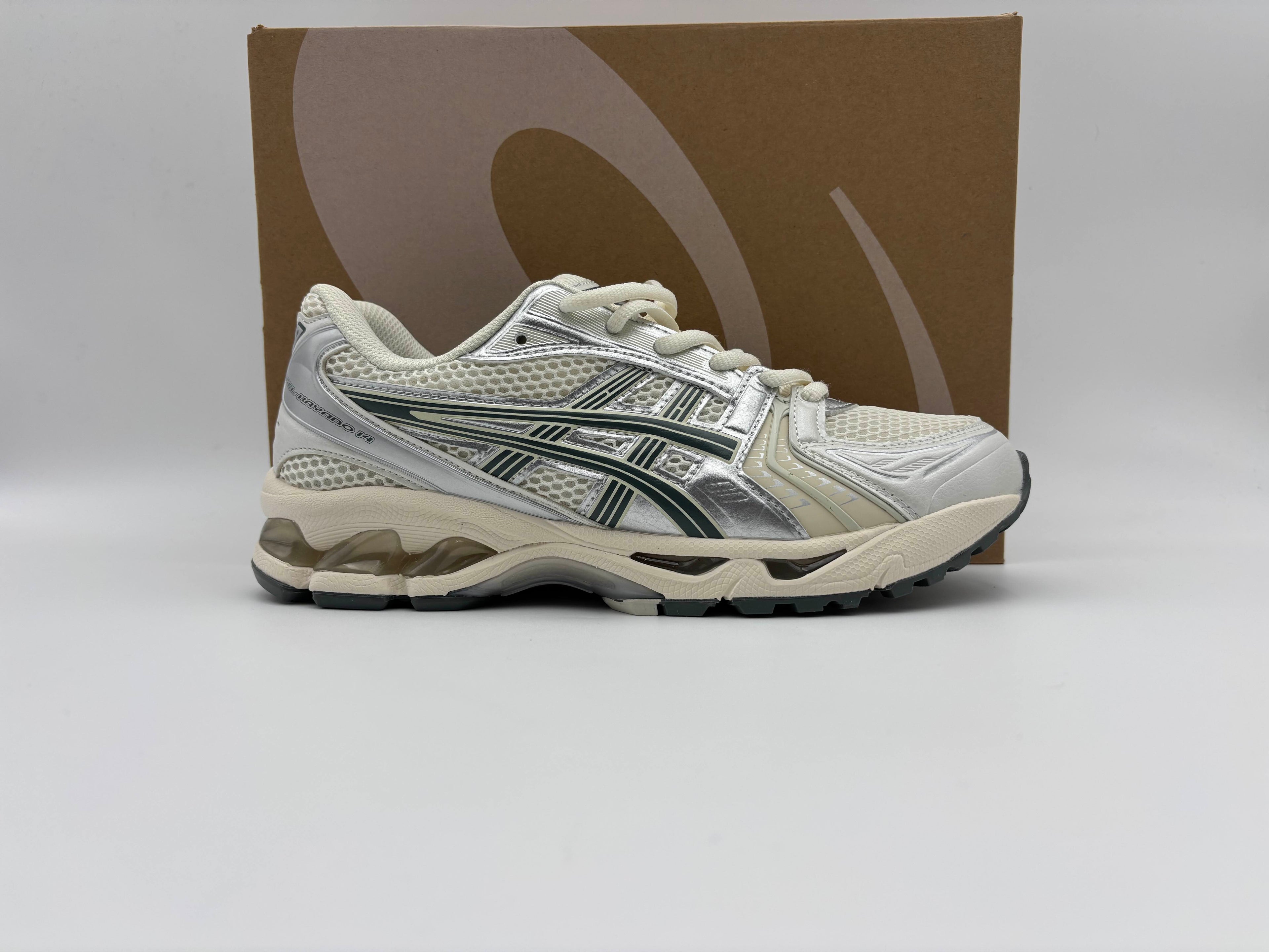 Side view of Asics Gel-Kayano 14 Birch Dark Pewter running shoes with cushioned GEL midsole, breathable mesh and synthetic upper, and durable rubber outsole for comfort and performance.