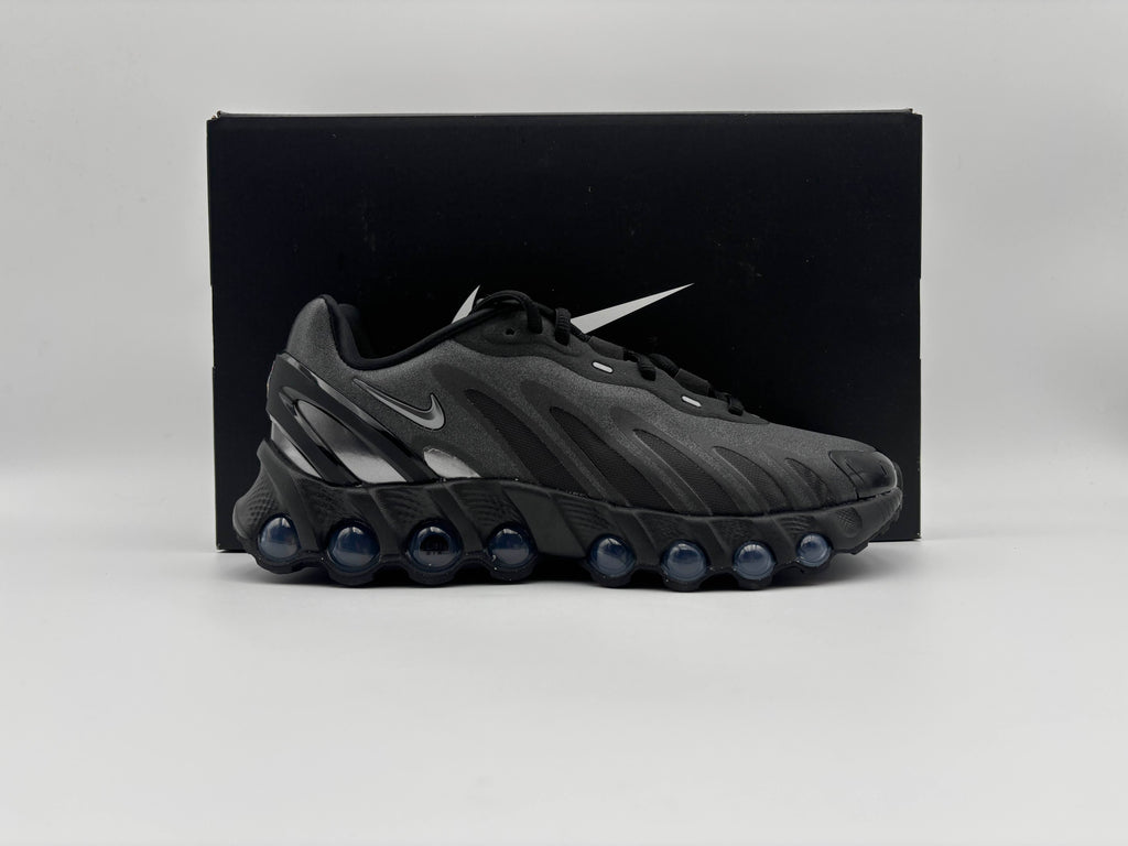 Side view of Nike Air Max Dn8 Black Metallic Dark Grey sneakers with sleek low-top design, breathable mesh upper, and dynamic Air cushioning for comfort and modern streetwear style