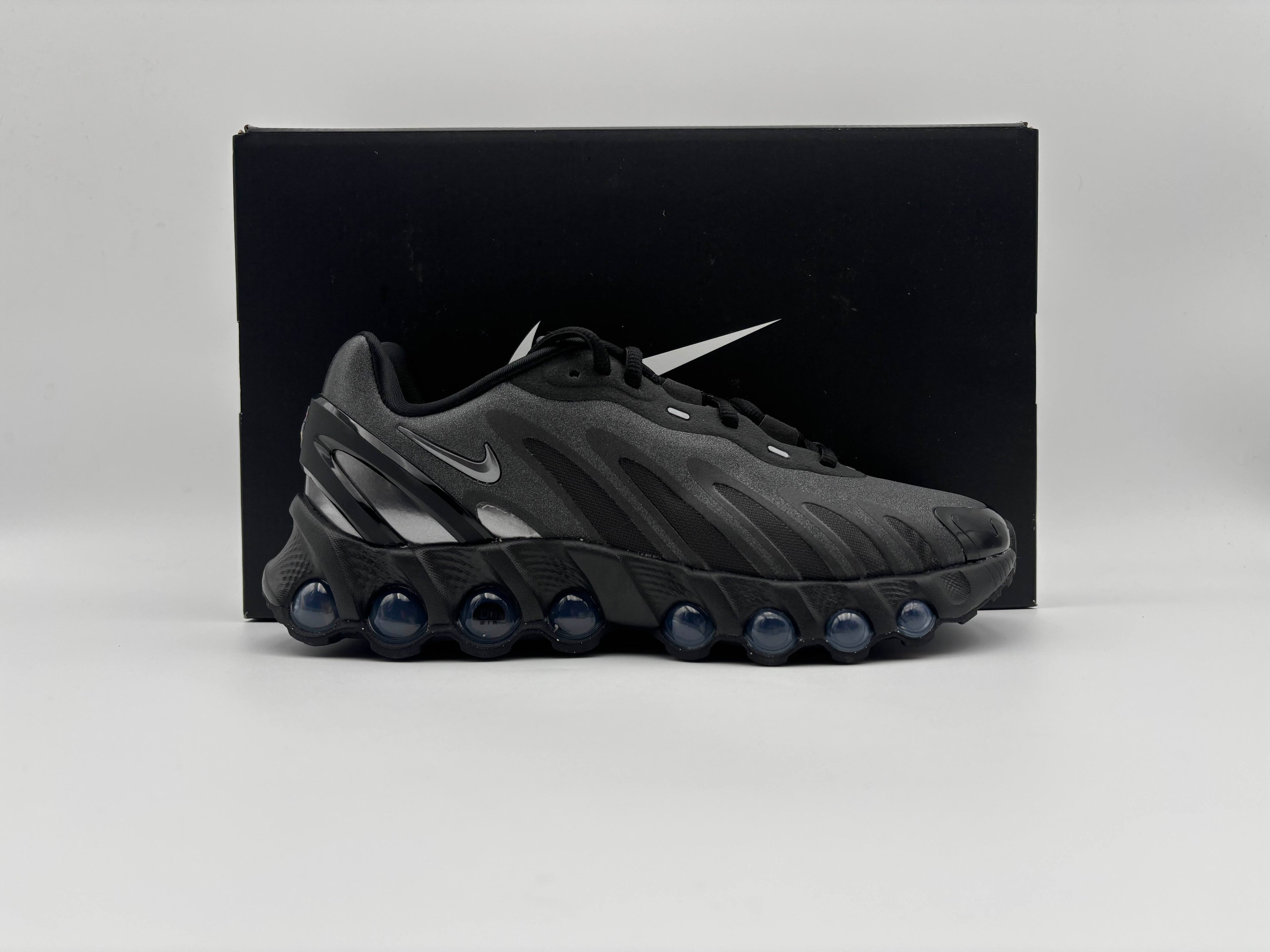 Side view of Nike Air Max Dn8 Black Metallic Dark Grey sneakers with sleek low-top design, breathable mesh upper, and dynamic Air cushioning for comfort and modern streetwear style
