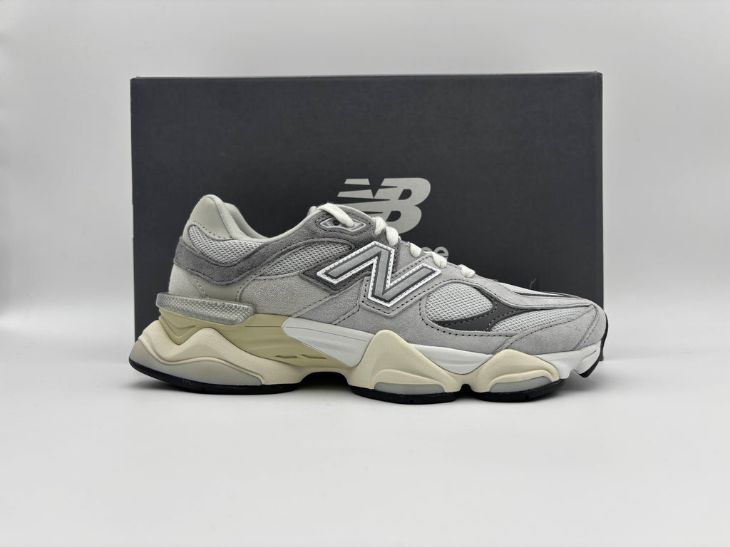 New Balance 9060 Rain Cloud Grey sneaker displayed in front of New Balance box on a clean white background, brand-new lifestyle running shoe.