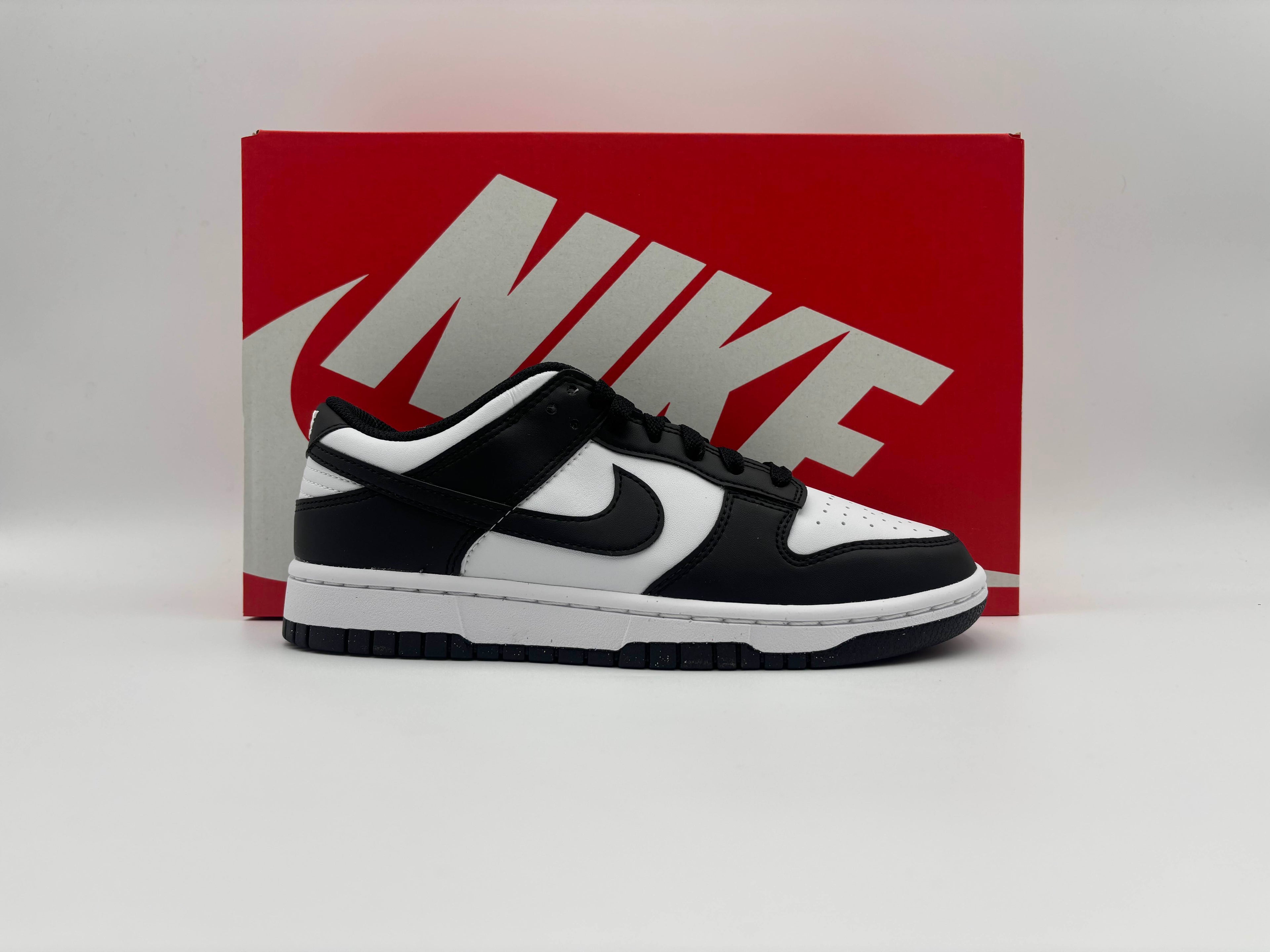 Nike Dunk Low Next Nature Panda brand new black and white sneaker displayed in front of Nike box.