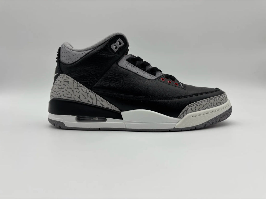 Side view of Air Jordan 3 OG Black Cement 2024 sneakers with iconic high-top design, leather upper, elephant print accents, and visible Air cushioning for basketball performance and streetwear style
